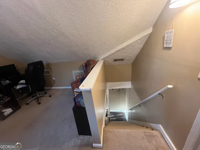 a view of a workspace with furniture and wooden floor