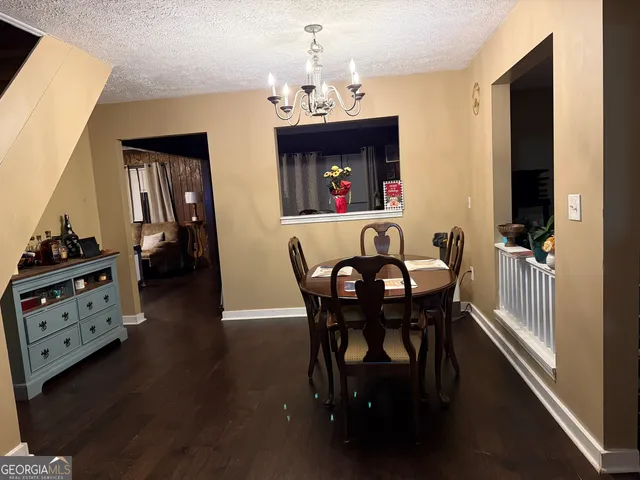 a view of a dining room with furniture and chandelier