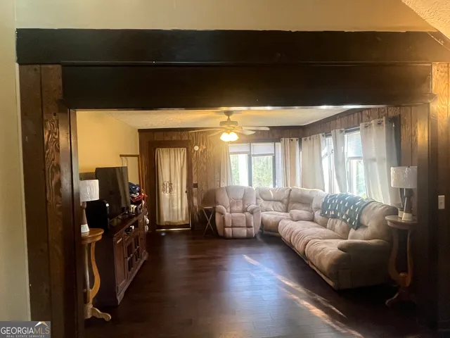a living room with furniture and wooden floor