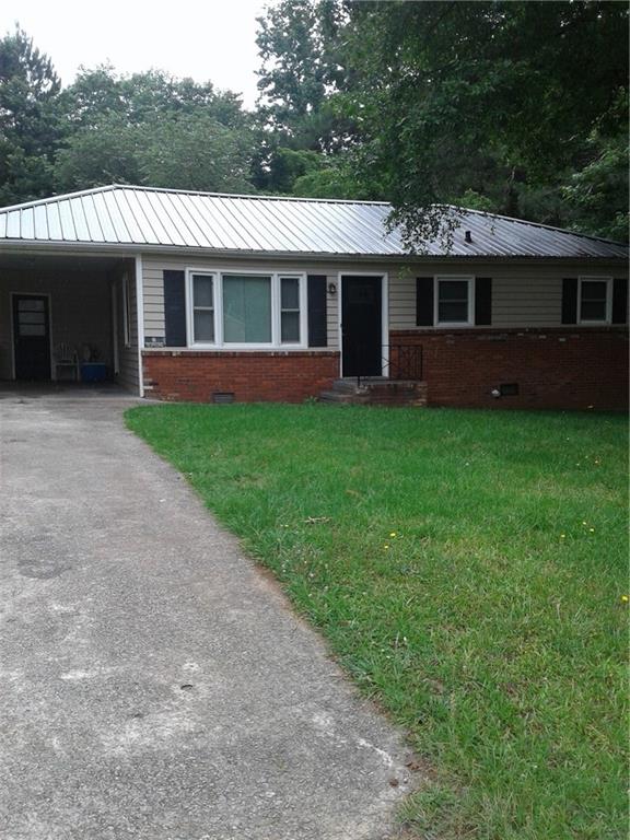 5105 Flint Hill Road Southwest Austell, GA 30106 - Photo 1 of 1 a front view of a house with a garden and porch