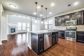 a view of backyard with wooden fence and large trees