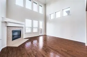 a large kitchen with stainless steel appliances granite countertop a stove and a wooden floors