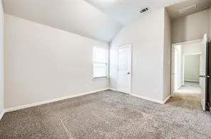 an empty room with chandelier fan and windows
