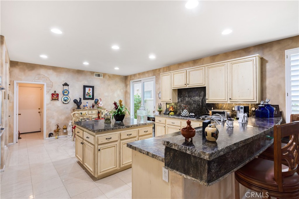 12665 Stanton Avenue Tustin, CA 92782 - Photo 11 of 52 a kitchen with counter top space appliances and cabinets