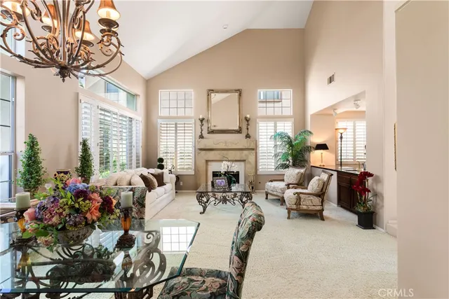 a living room with fireplace furniture and a large window