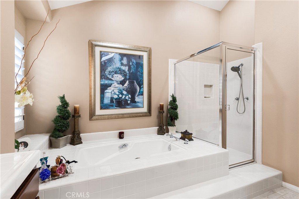 12665 Stanton Avenue Tustin, CA 92782 - Photo 25 of 52 a bathroom with a tub a sink and a large mirror