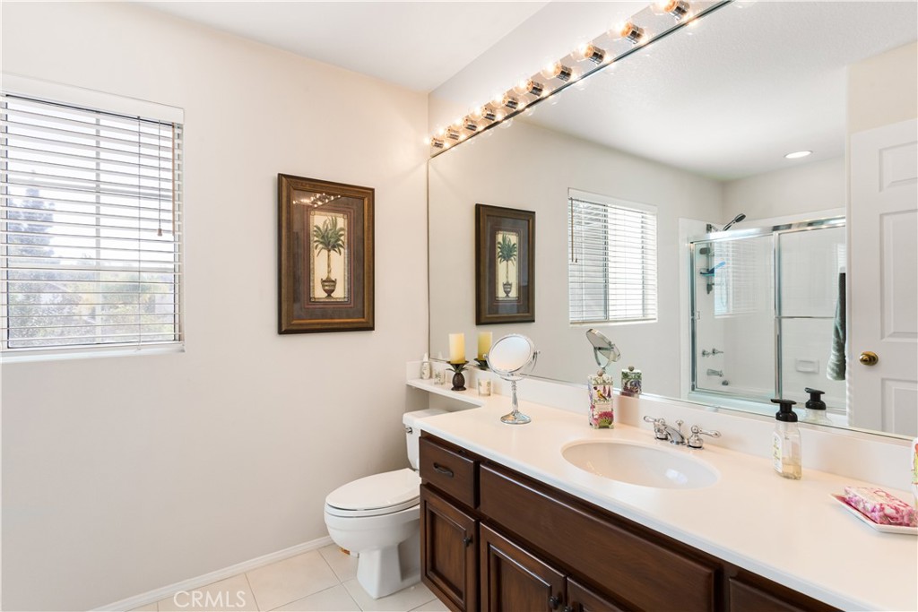12665 Stanton Avenue Tustin, CA 92782 - Photo 28 of 52 a bathroom with a double vanity sink toilet and a mirror
