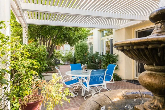 a view of a patio with table and chairs and potted plants