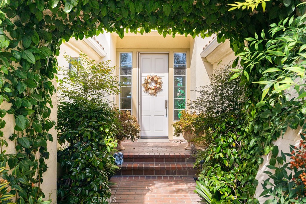 12665 Stanton Avenue Tustin, CA 92782 - Photo 35 of 52 a view of a house with potted plants and a fountain