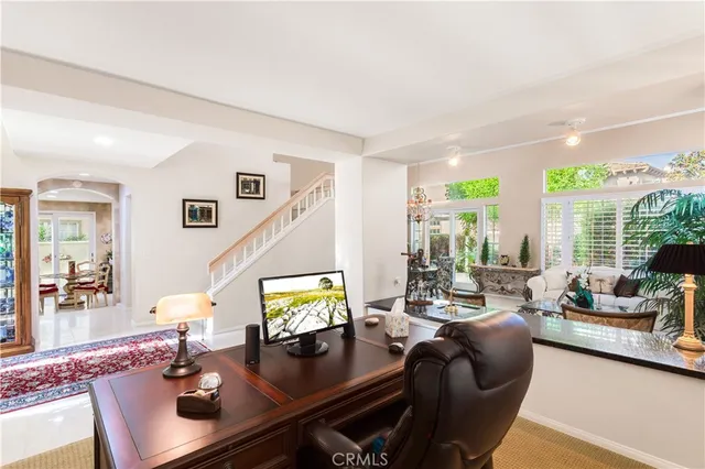 a living room with furniture and large windows