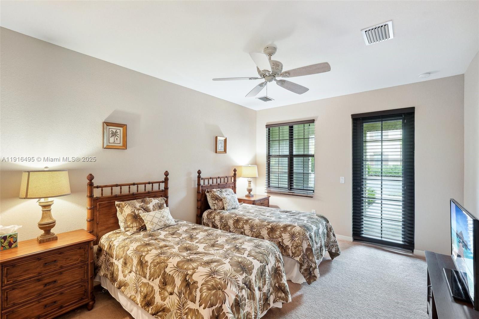 9064 Capistrano Street North, Unit 5004 Naples, FL 34113 - Photo 19 of 27 a bedroom with two beds and a window