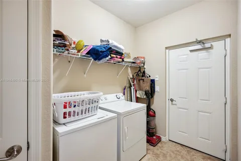 a bedroom with two beds and a chandelier