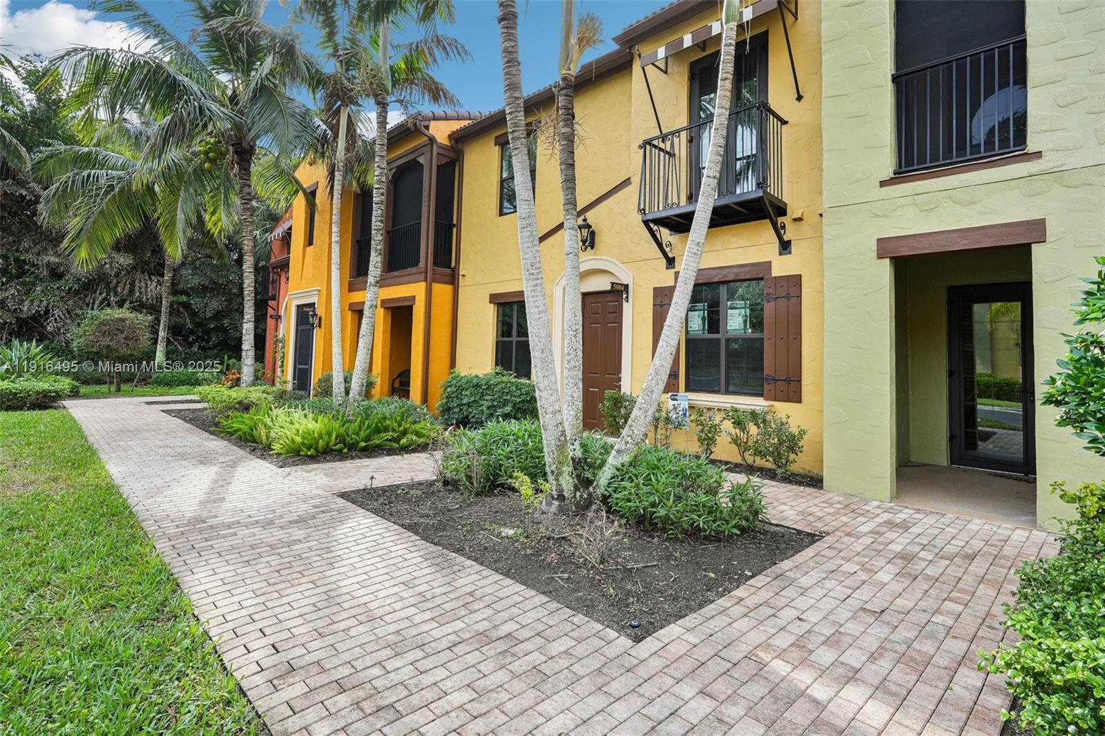 9064 Capistrano Street North, Unit 5004 Naples, FL 34113 - Photo 3 of 27 a view of a building with a yard