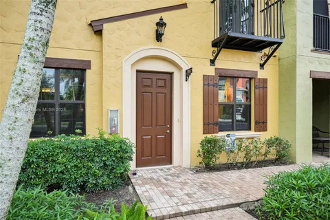 a view of a brick house with potted plants