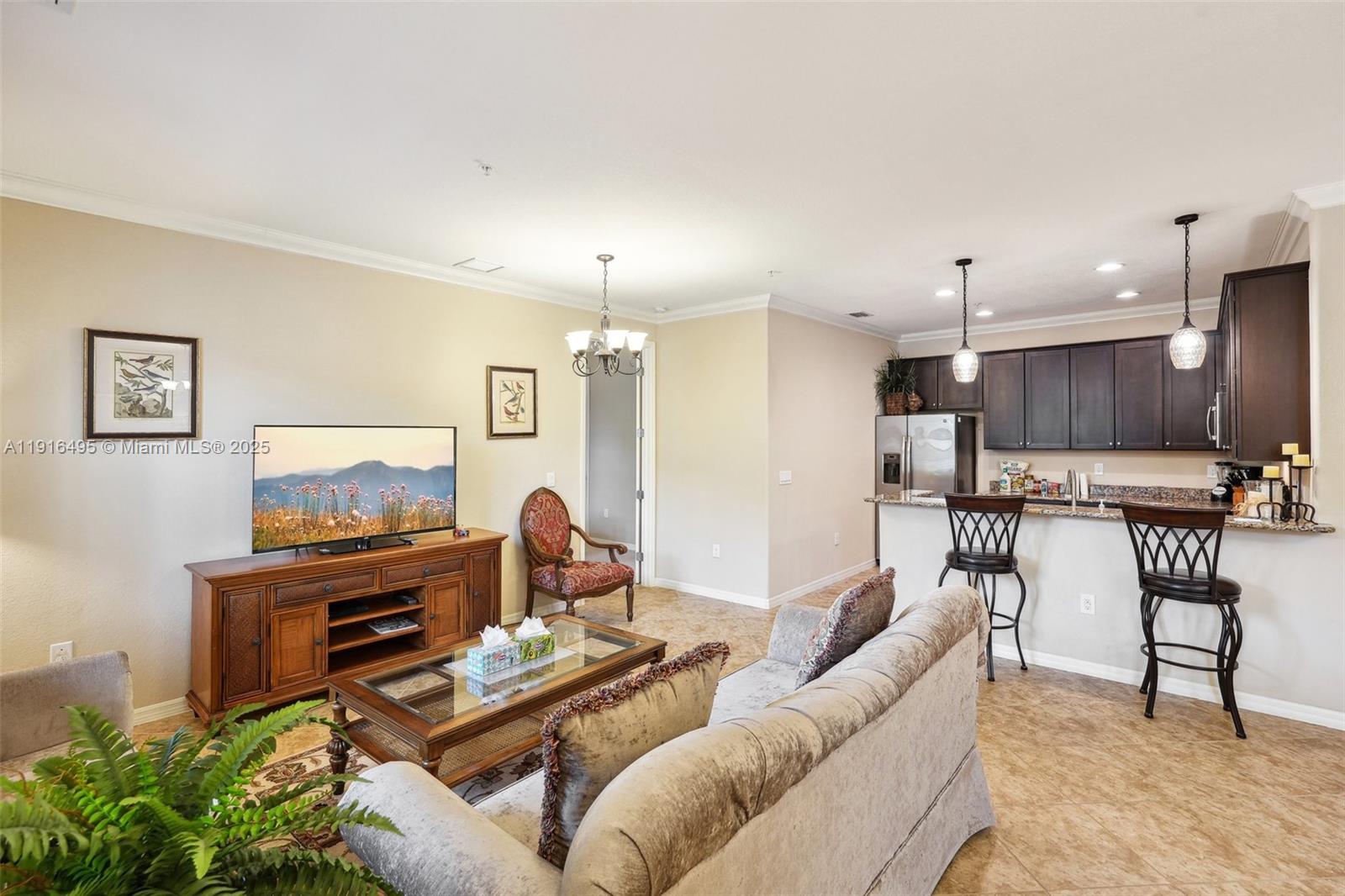 9064 Capistrano Street North, Unit 5004 Naples, FL 34113 - Photo 7 of 27 a living room with furniture and kitchen view