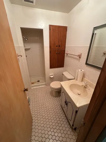 a view of a closet area with wooden floor