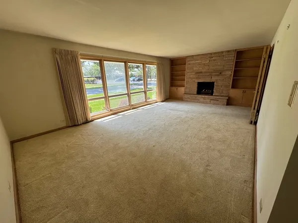 a view of empty room with a fireplace