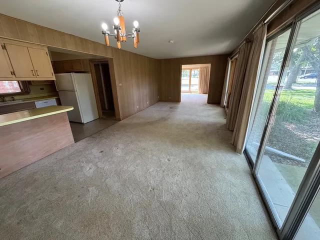 a view of a big room with windows and chandelier