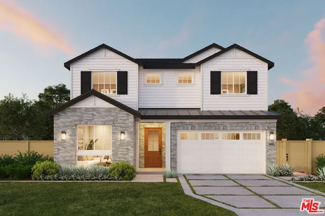a front view of a house with a yard and trees