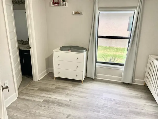 a bathroom with a granite countertop sink a mirror and a shower