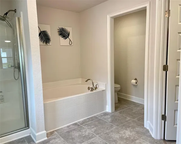 a bathroom with a granite countertop sink and a toilet