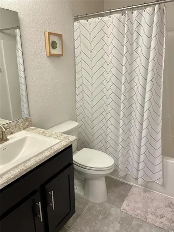 a bathroom with a sink a toilet and a tub