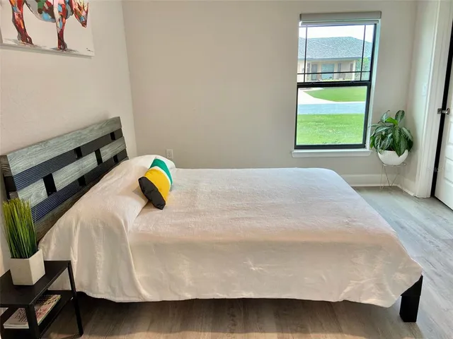 a bedroom with a bed and a window