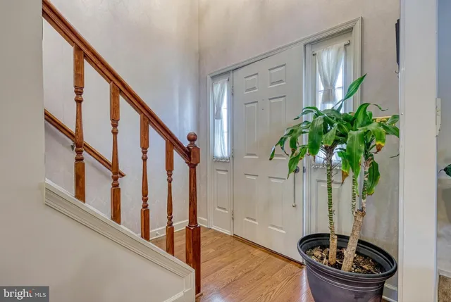 a view of entryway with wooden floor and stairs