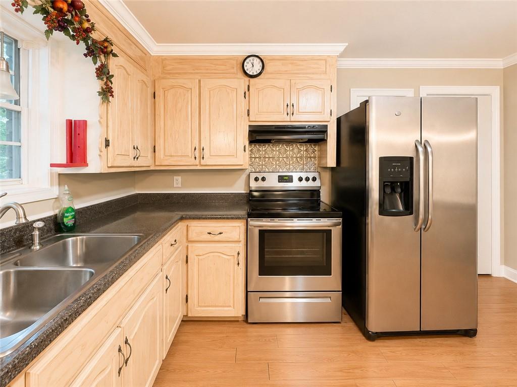 212 Craigtown Road Northeast Calhoun, GA 30701 - Photo 6 of 21 a kitchen with stainless steel appliances kitchen island granite countertop a refrigerator and a sink