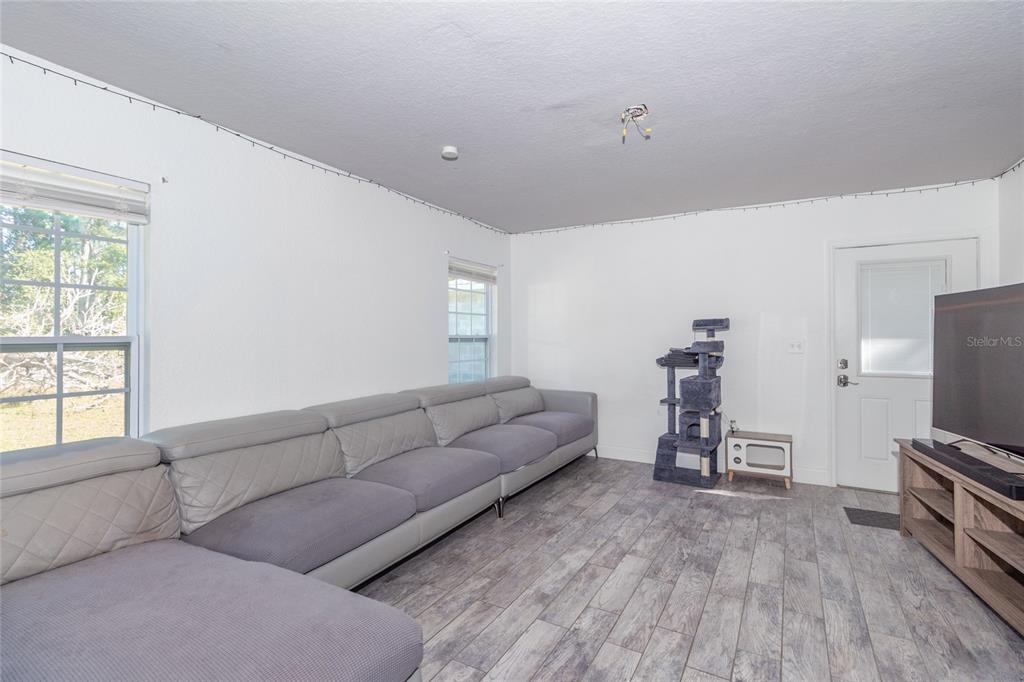 6447 Brandy Drive Spring Hill, FL 34607 - Photo 14 of 25 a living room with furniture and a flat screen tv