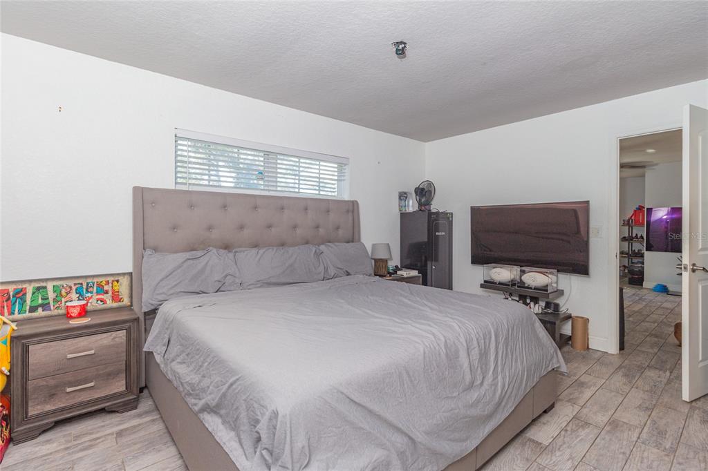 6447 Brandy Drive Spring Hill, FL 34607 - Photo 16 of 25 a bedroom with a bed and a flat screen tv