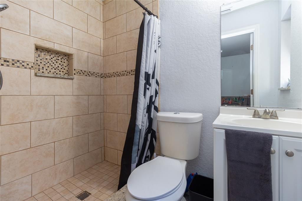 6447 Brandy Drive Spring Hill, FL 34607 - Photo 17 of 25 a white toilet sitting next to a bathroom sink