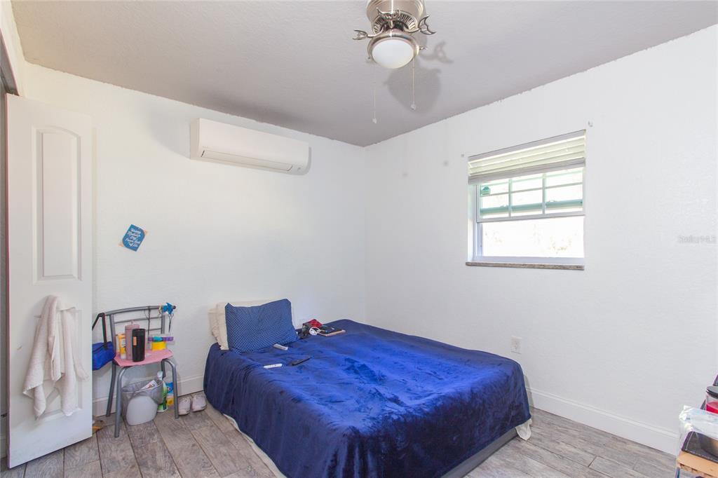 6447 Brandy Drive Spring Hill, FL 34607 - Photo 18 of 25 a bed sitting in a bedroom next to a window