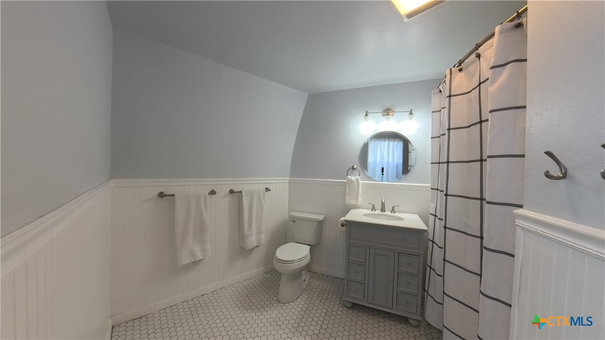 929 Red Bluff Ranch Road Pipe Creek, TX 78063 - Photo 15 of 39 a bathroom with a toilet sink and mirror