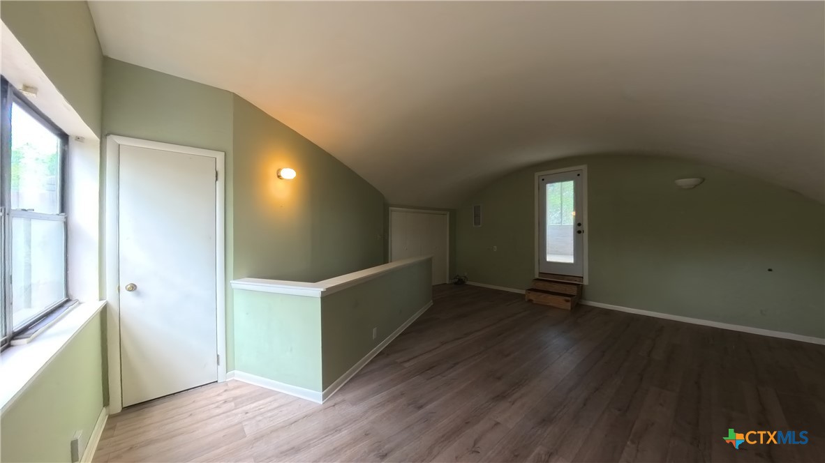 929 Red Bluff Ranch Road Pipe Creek, TX 78063 - Photo 19 of 39 a view of an empty room with wooden floor and a window