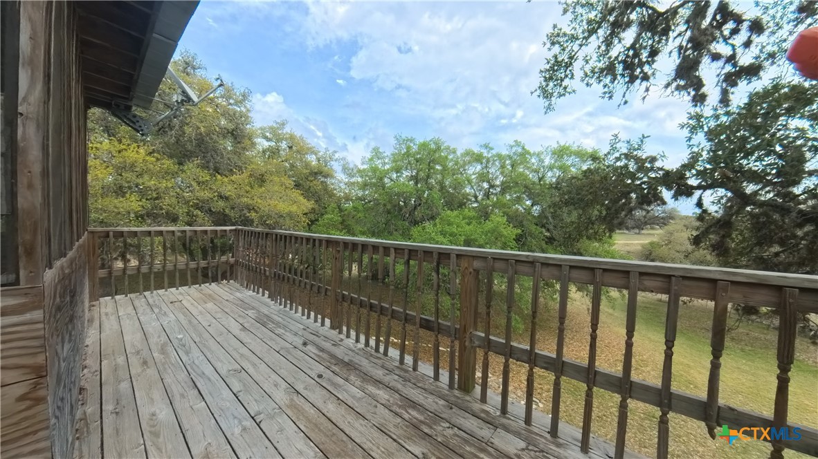 929 Red Bluff Ranch Road Pipe Creek, TX 78063 - Photo 22 of 39 a balcony with wooden floor and fence