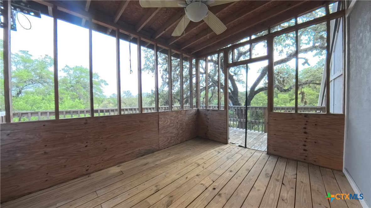 929 Red Bluff Ranch Road Pipe Creek, TX 78063 - Photo 23 of 39 a view of wooden floor and trees in a room