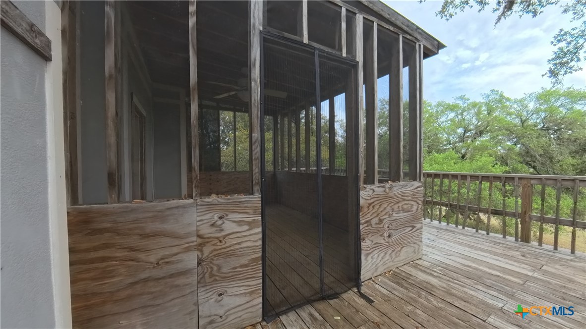 929 Red Bluff Ranch Road Pipe Creek, TX 78063 - Photo 24 of 39 a view of a balcony with wooden floor and wooden fence