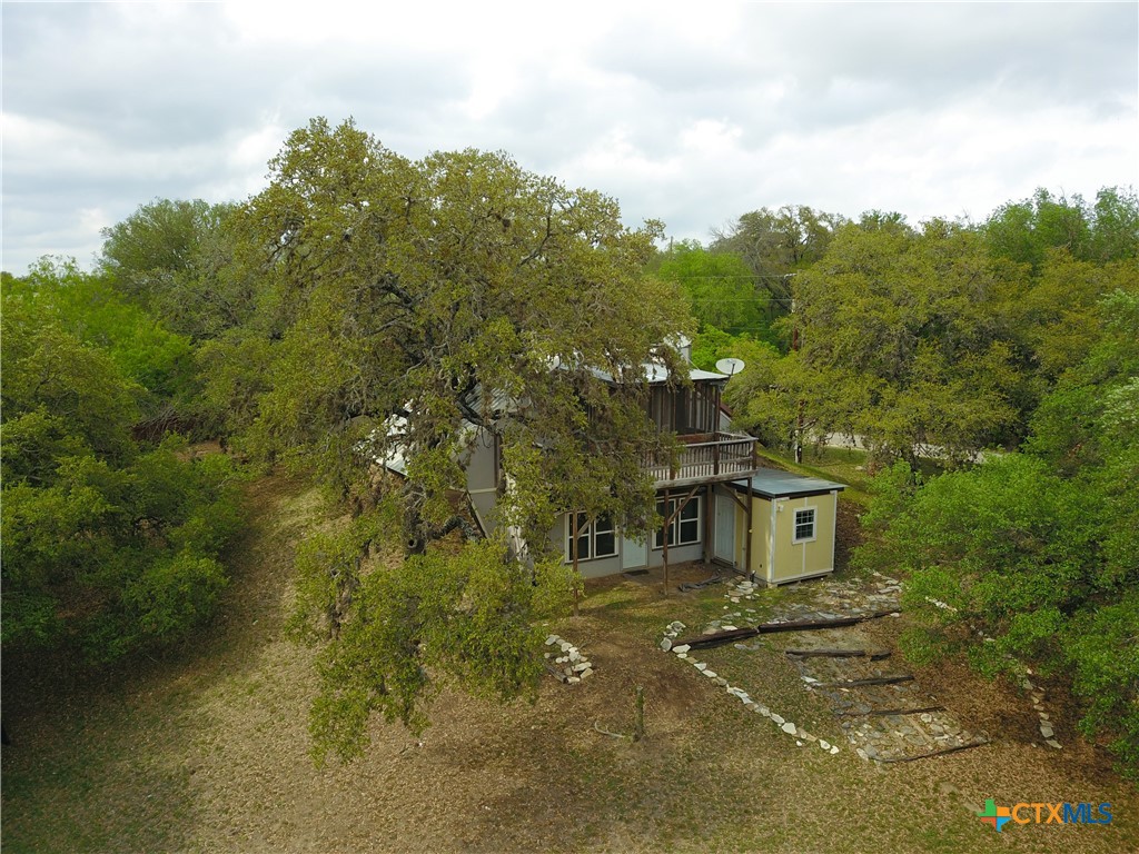 929 Red Bluff Ranch Road Pipe Creek, TX 78063 - Photo 3 of 39 a front view of a house with a yard