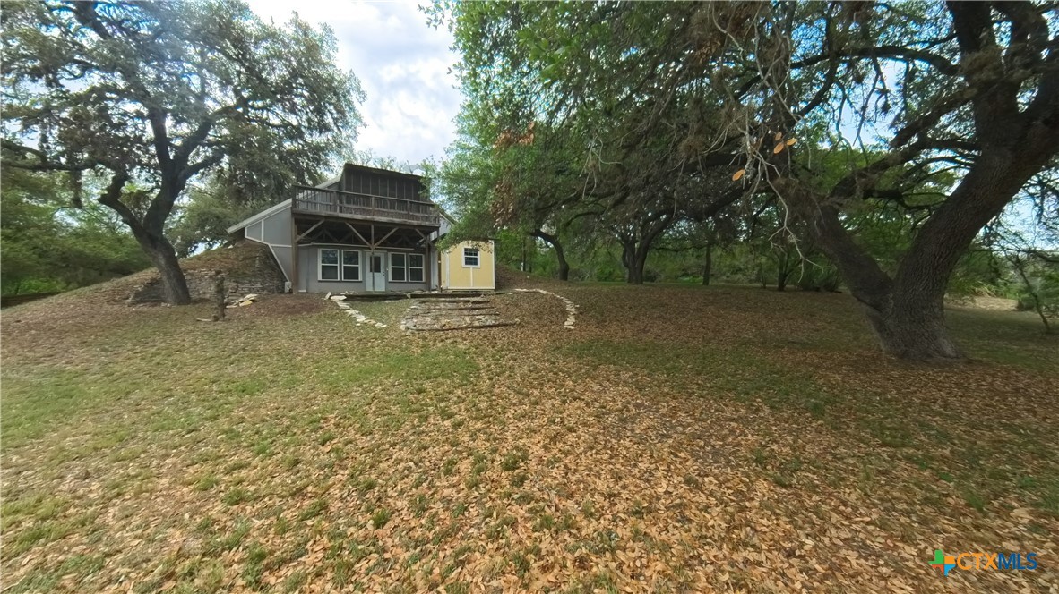 929 Red Bluff Ranch Road Pipe Creek, TX 78063 - Photo 32 of 39 a front view of a house with a yard