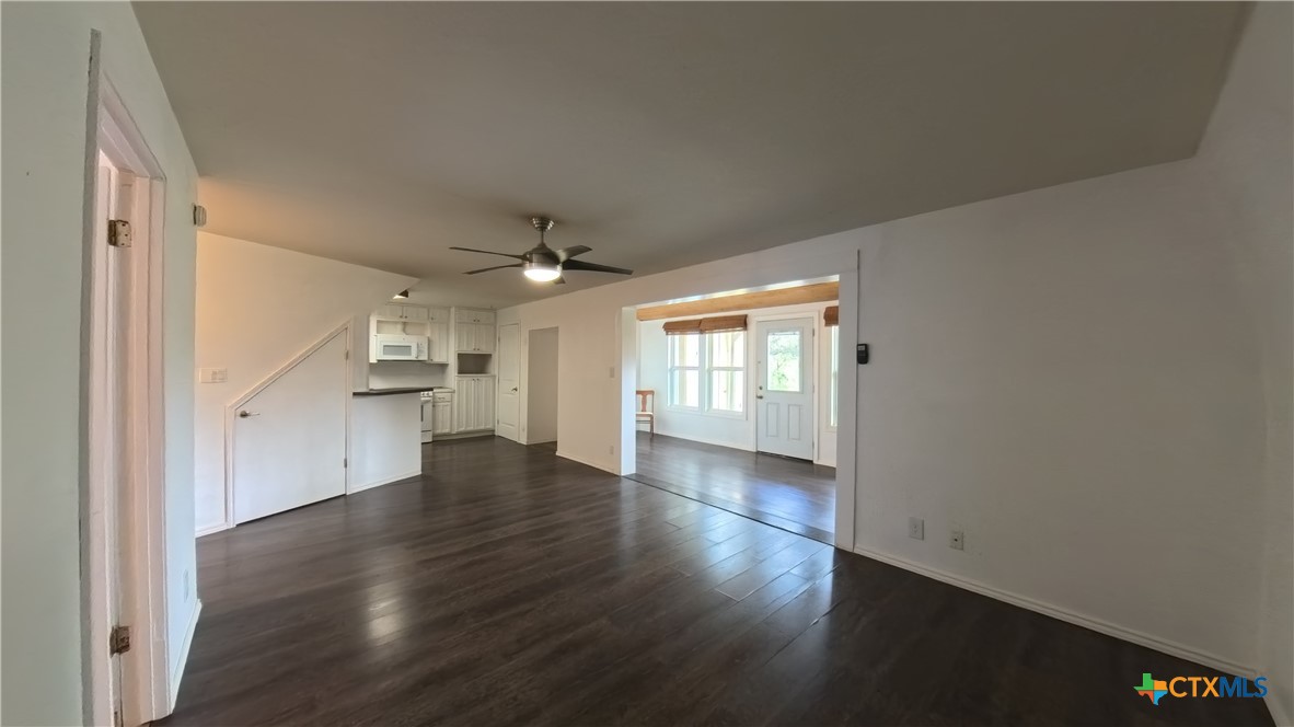 929 Red Bluff Ranch Road Pipe Creek, TX 78063 - Photo 4 of 39 an empty room with wooden floor cabinet and windows