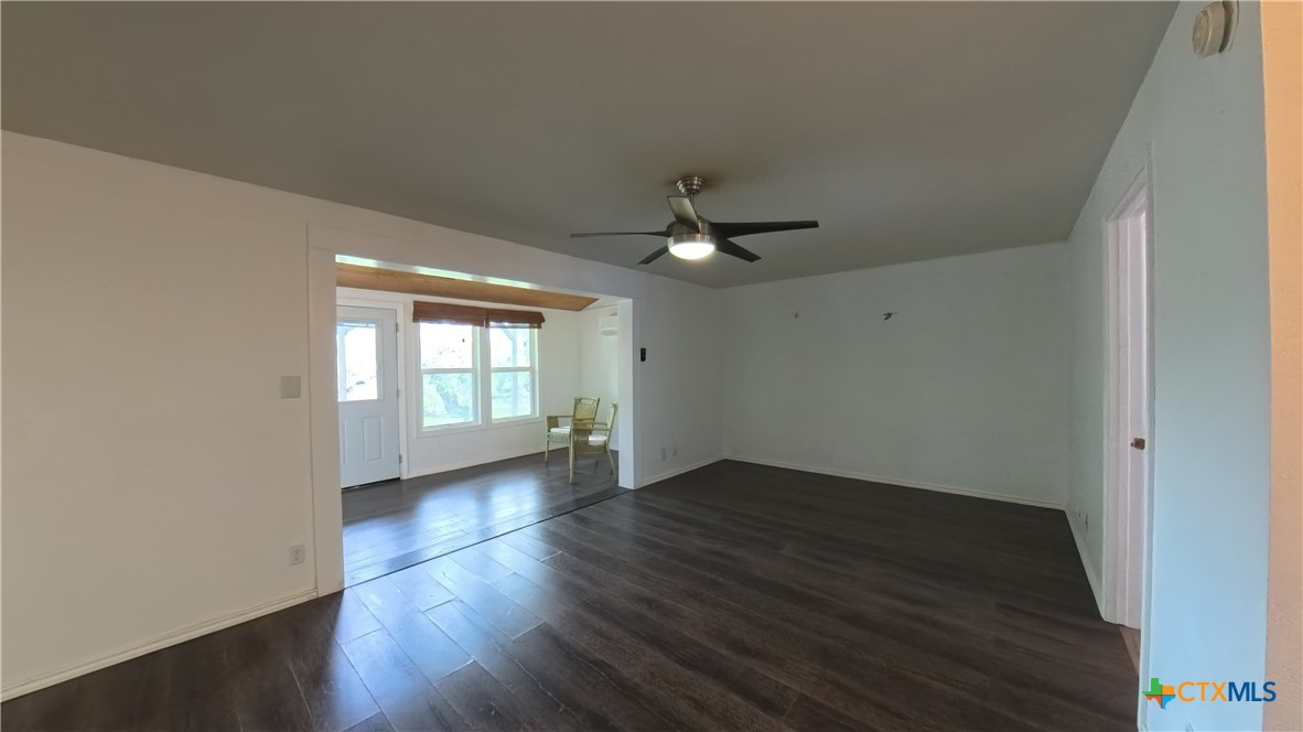 929 Red Bluff Ranch Road Pipe Creek, TX 78063 - Photo 6 of 39 an empty room with wooden floor and windows