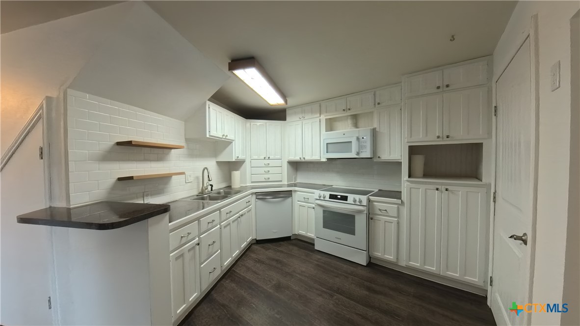 929 Red Bluff Ranch Road Pipe Creek, TX 78063 - Photo 7 of 39 a kitchen with stainless steel appliances granite countertop a stove and a refrigerator