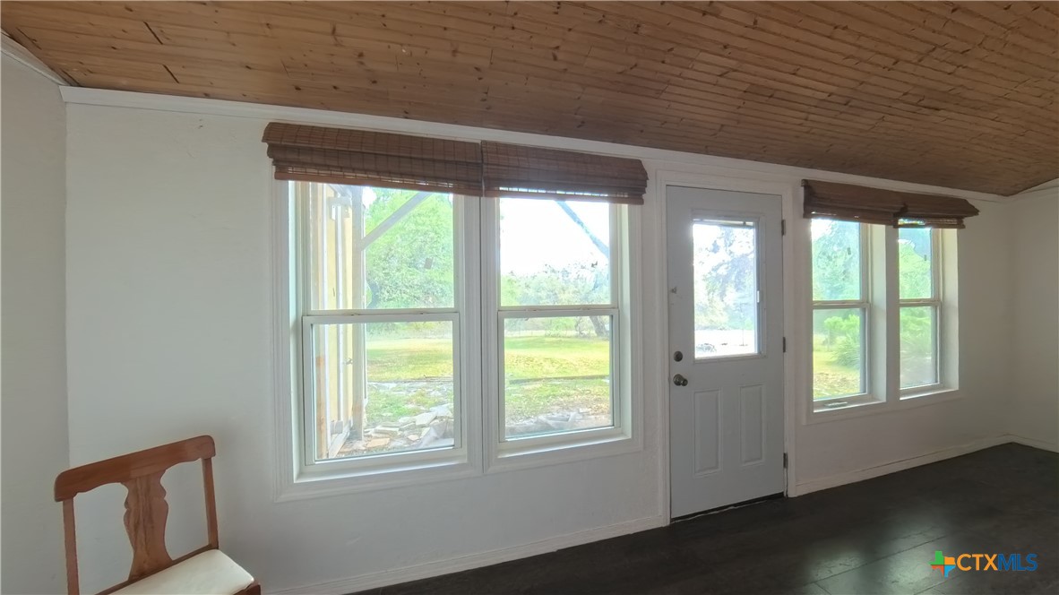 929 Red Bluff Ranch Road Pipe Creek, TX 78063 - Photo 10 of 39 a view of an empty room with wooden floor and a window