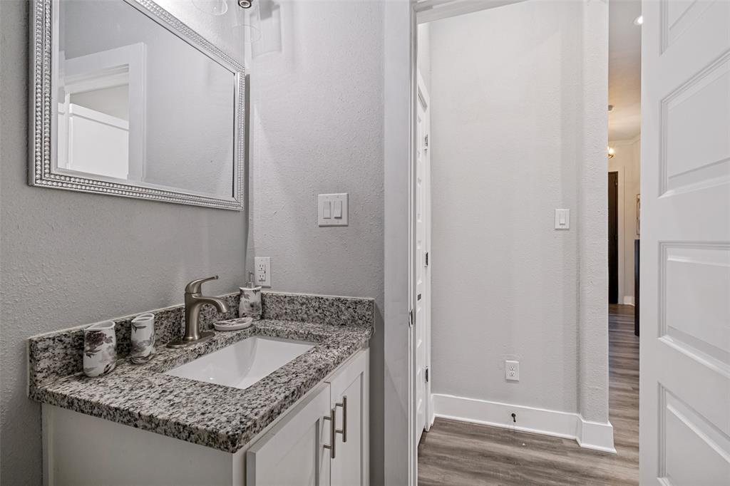 7909 Ivory Lane Dallas, TX 75216 - Photo 11 of 20 a bathroom with a granite countertop sink and a mirror