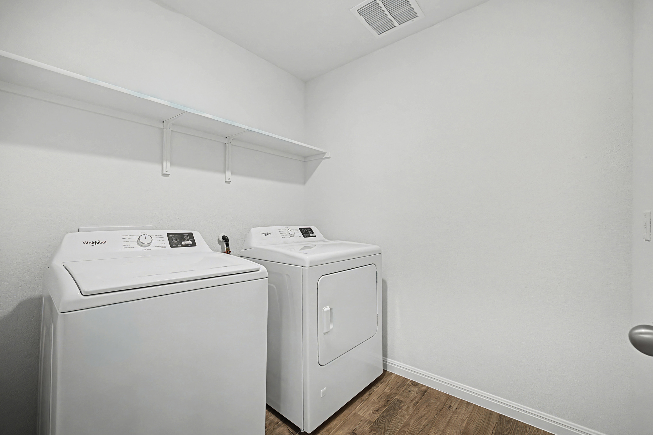 1908 Pogonip Place Leander, TX 78641 - Photo 14 of 21 Laundry room featuring dark wood-type flooring and separate washer and dryer