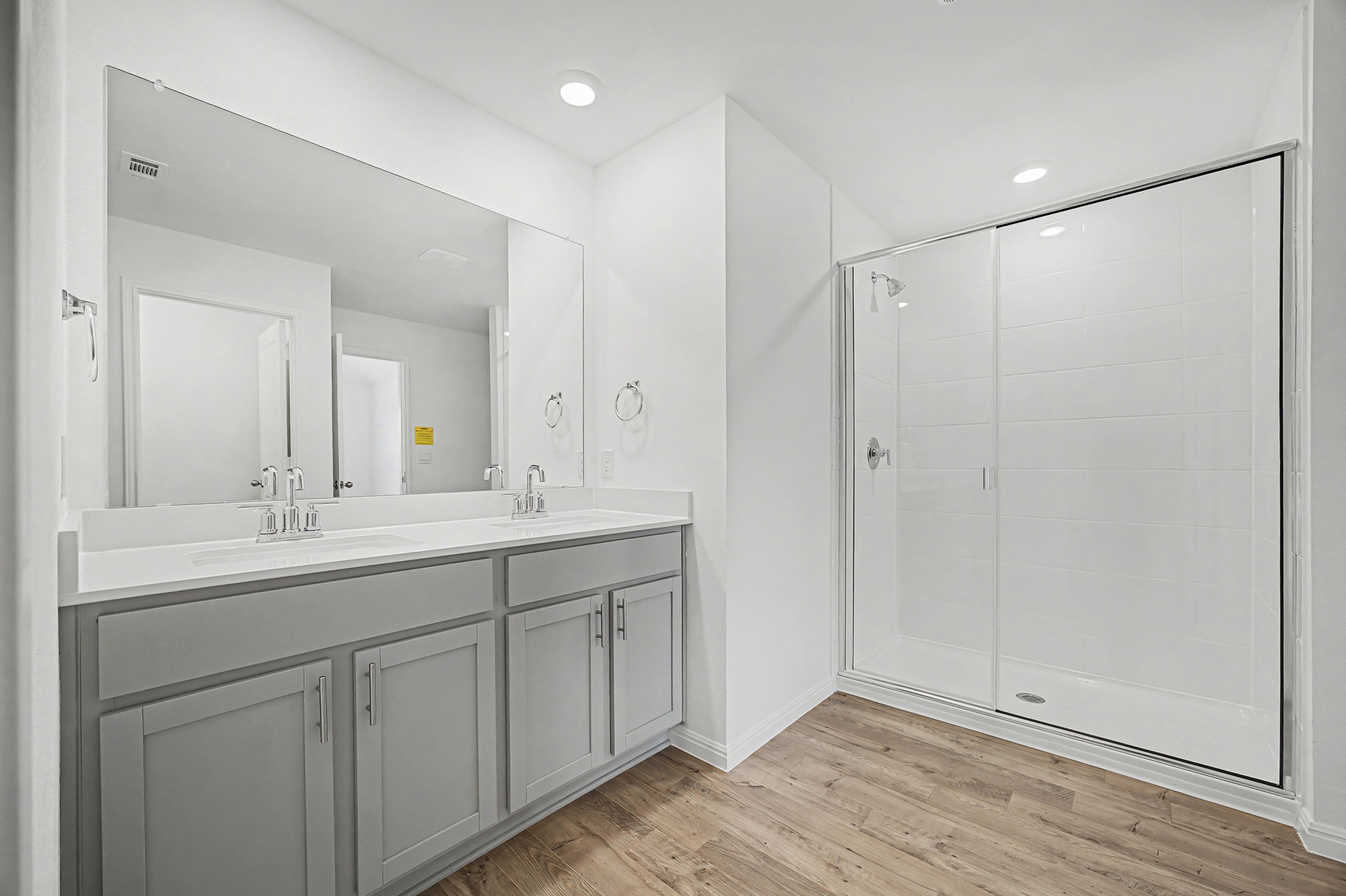 1908 Pogonip Place Leander, TX 78641 - Photo 17 of 21 Bathroom featuring double vanity, a stall shower, light wood-style floors, and recessed lighting