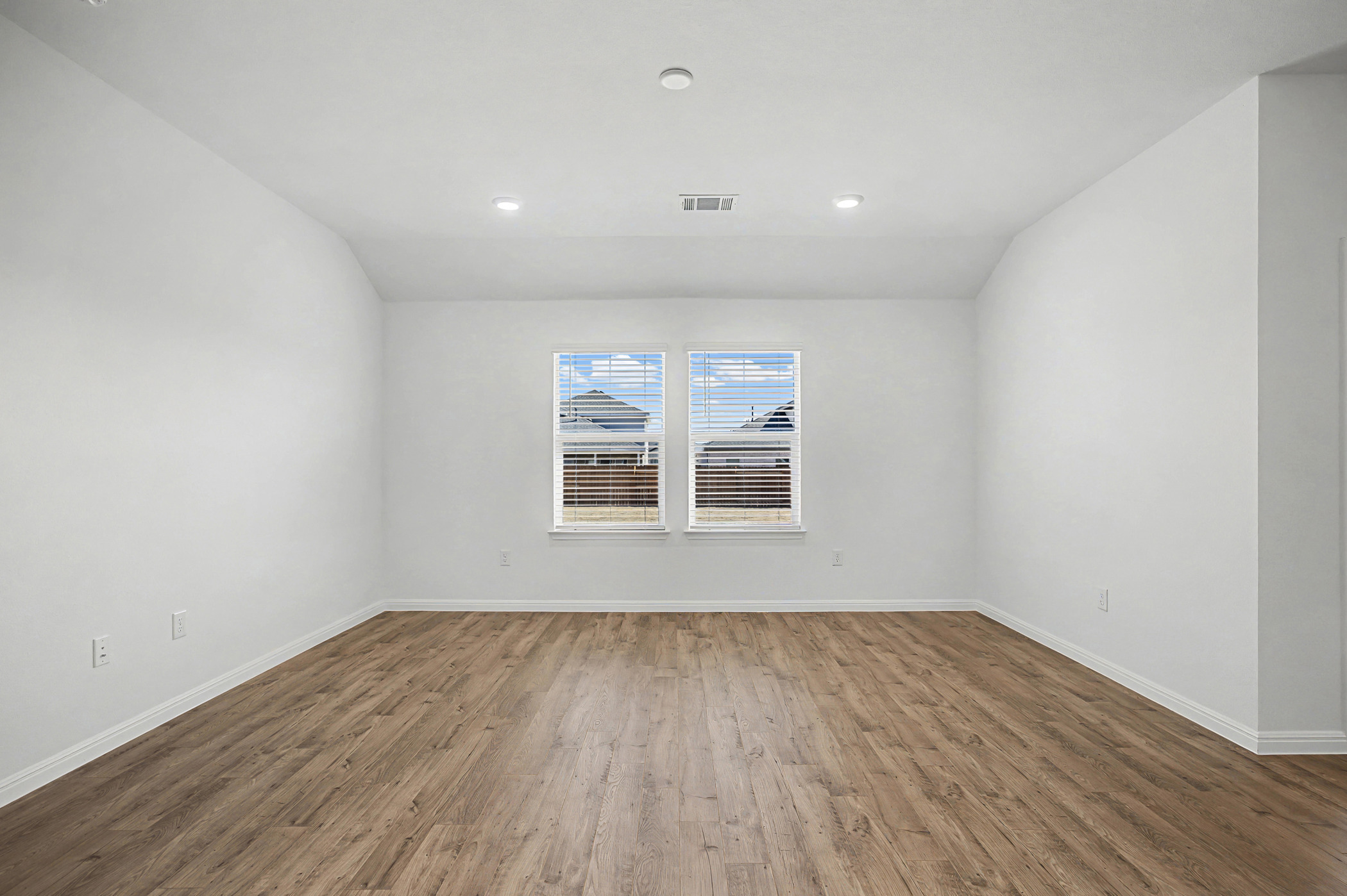 1908 Pogonip Place Leander, TX 78641 - Photo 7 of 21 Spare room featuring dark wood-style flooring and vaulted ceiling