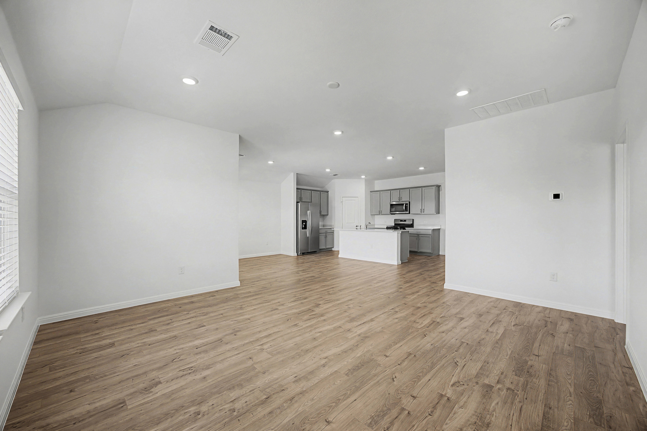 1908 Pogonip Place Leander, TX 78641 - Photo 9 of 21 Unfurnished living room featuring light wood-style flooring and recessed lighting