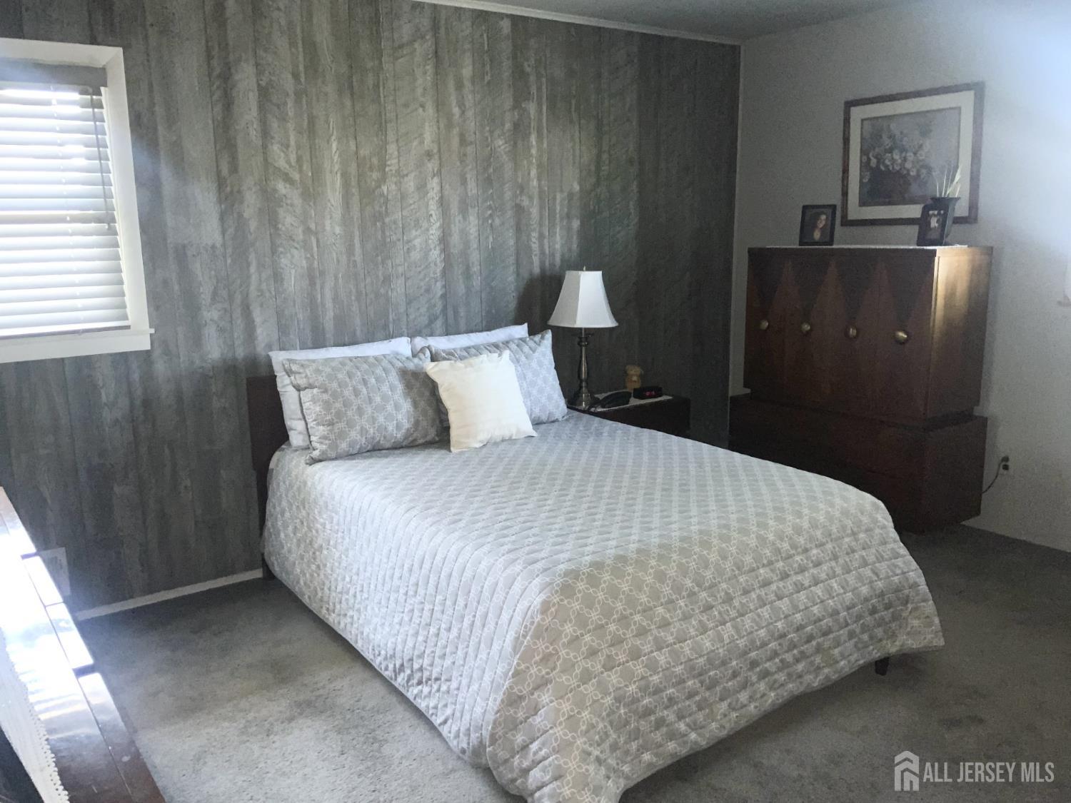 178 Willow Street Port Reading, NJ 07064 - Photo 8 of 15 a bedroom with a bed and a night stand